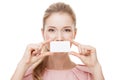 Beautiful woman holding white card at front of her lips. Isolated. Royalty Free Stock Photo
