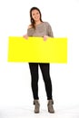 Beautiful woman holding a yellow, blank paper