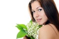 Beautiful woman holds a flower of a lily of the valley Royalty Free Stock Photo