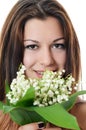 The beautiful woman holds a flower of a lily of the valley Royalty Free Stock Photo