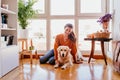 beautiful woman hugging her adorable golden retriever dog at home. love for animals concept. lifestyle indoors Royalty Free Stock Photo