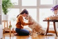 beautiful woman hugging her adorable golden retriever dog at home. love for animals concept. lifestyle indoors Royalty Free Stock Photo