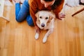 beautiful woman hugging her adorable golden retriever dog at home. love for animals concept. lifestyle indoors