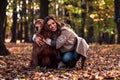 Beautiful woman hugging her brown purebred dog in the autumn park. Love, care for your pet Royalty Free Stock Photo