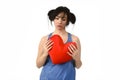 Beautiful woman hurt and suffering for lost love holding red heart shape pillow