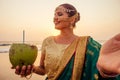 Beautiful woman indian green fashion sari, bindis drinking coco nut water. indian woman perfect makeup tikka , nath,nose Royalty Free Stock Photo