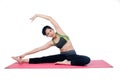 Beautiful woman indoor exercising using pink yoga mat