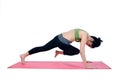 Beautiful woman indoor exercising using pink yoga mat