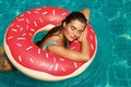 Beautiful woman and inflatable swim ring in shape of donut Royalty Free Stock Photo