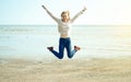 Beautiful woman jeans sweater jumping laughing Royalty Free Stock Photo