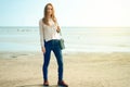 Beautiful woman in a jeans sweater shoes female bag Royalty Free Stock Photo