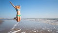 Beautiful woman jump on the beach in the sea Royalty Free Stock Photo