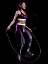 Beautiful woman jumping rope fitness exercises isolated black background Royalty Free Stock Photo