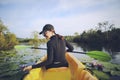 Beautiful woman kayaking through water lilly in mangrove canal Royalty Free Stock Photo