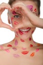 Beautiful woman with kisses on her face shows heart Royalty Free Stock Photo