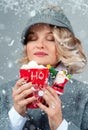 Beautiful woman in knitted hat is drinking hot coffee. Happy holiday Royalty Free Stock Photo