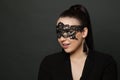 Beautiful woman in lace black carnival mask on dark background Royalty Free Stock Photo