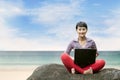 Beautiful woman with laptop at the beach Royalty Free Stock Photo
