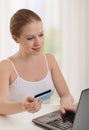 Beautiful woman with laptop makes payment online