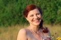 Beautiful woman laughs at sunny day outdoor at summer