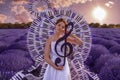 Beautiful woman in lavender field with treble clef and piano throne Royalty Free Stock Photo