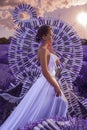 Beautiful woman in lavender field with treble clef and piano throne Royalty Free Stock Photo