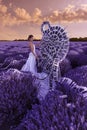 Beautiful woman in lavender field with treble clef and piano throne Royalty Free Stock Photo