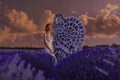 Beautiful woman in lavender field with treble clef and piano throne Royalty Free Stock Photo