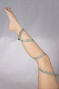 Beautiful woman leg with a coiled measure tape Royalty Free Stock Photo