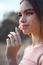 Beautiful woman licking a lollipop close-up. Red shadows on the eyes of a girl, professional makeup, natural cosmetics Royalty Free Stock Photo