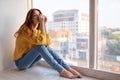 beautiful woman lies near the window dreamy look Royalty Free Stock Photo