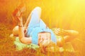 Beautiful woman lies in the wild flowers field and reading a book. Summer holiday, rest and education concept. Horizontal imagee Royalty Free Stock Photo