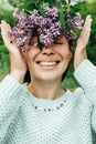 Beautiful woman with lilac flower wreath. Girl in a wreath of lilac in the spring. Royalty Free Stock Photo