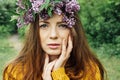 Beautiful woman with lilac flower wreath. Girl in a wreath of lilac in the spring. Royalty Free Stock Photo