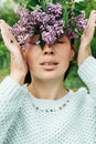 Beautiful woman with lilac flower wreath. Girl in a wreath of lilac in the spring. Royalty Free Stock Photo