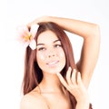 Beautiful woman with lily in her hair toching her chin. SPA treatment.