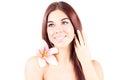 Beautiful woman with lily smiling with teeth and toching her hair. SPA treatment.