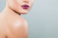 Beautiful woman lips with purple glossy lipstick and lipgloss on background with copy space Royalty Free Stock Photo