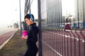 Woman listening to music while working out and jogging outdoor Royalty Free Stock Photo