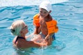 Beautiful woman and little boy bathes in pool Royalty Free Stock Photo