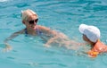 Beautiful woman and little boy bathes in pool Royalty Free Stock Photo