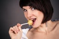 Beautiful woman with a lollipop in hand Royalty Free Stock Photo