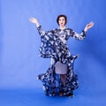 Beautiful woman with long flying dress on blue background Royalty Free Stock Photo