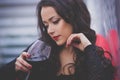 Beautiful woman with long hair drinking red wine in a restaurant Royalty Free Stock Photo