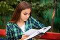 Beautiful woman with long hair are reading book outdoors Royalty Free Stock Photo