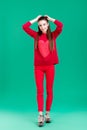 Woman in red sweater on green background Royalty Free Stock Photo