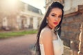 Beautiful woman with long hair wearing white wedding dress outdoors. Beauty fashion model with jewelry and makeup Royalty Free Stock Photo