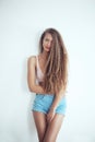 Beautiful woman with long hair in white room Royalty Free Stock Photo