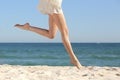 Beautiful woman long legs jumping on the beach Royalty Free Stock Photo