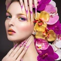 Beautiful woman with long nails, perfect skin, hair of orchids. Royalty Free Stock Photo